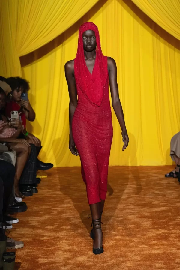 Model wearing red dress at Theophilio runway show LAFW 2023