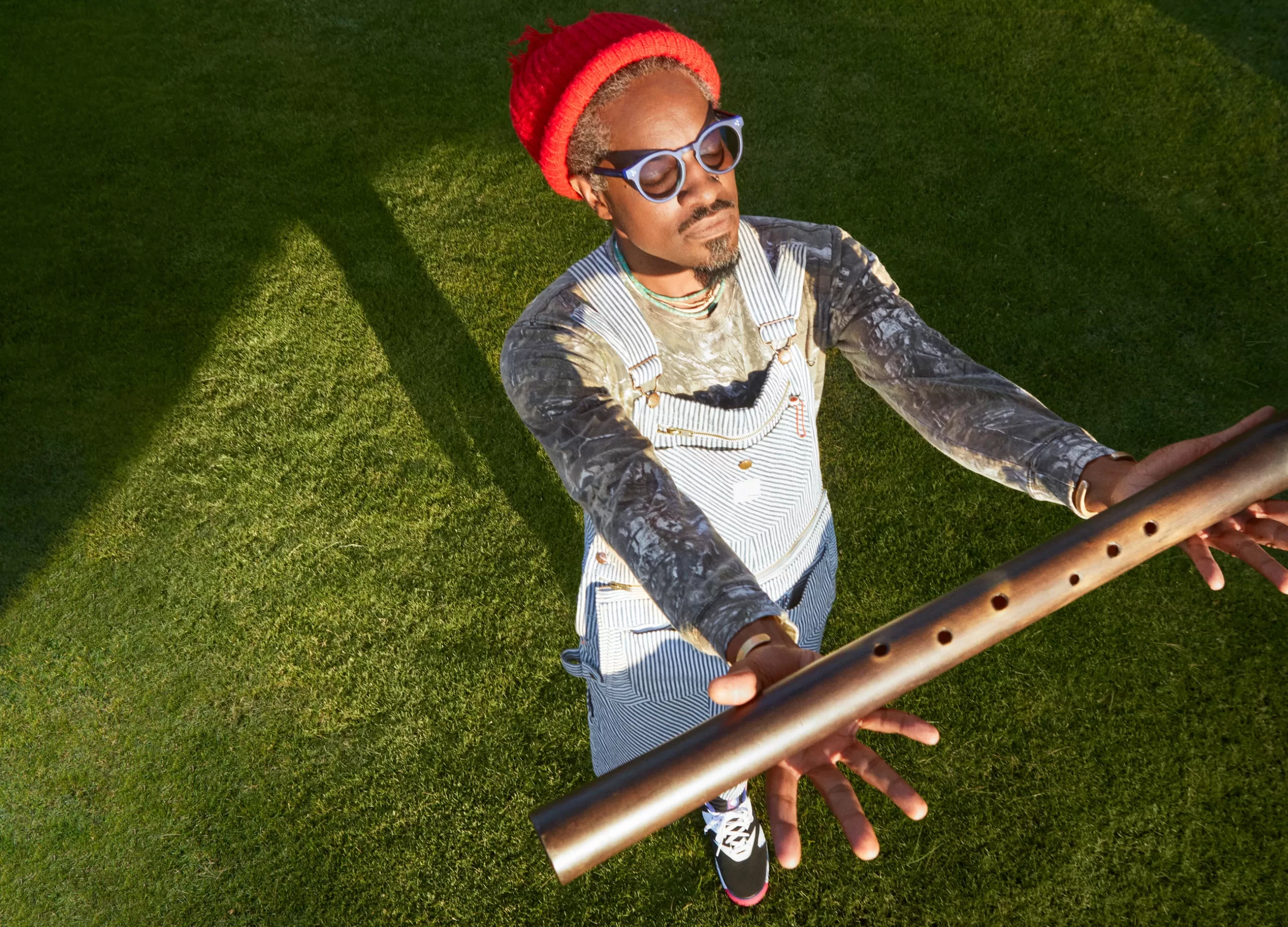 André 3000 holding flute in promotional photo for his album New Blue Sun