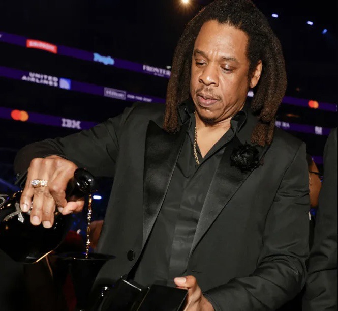 Jay-Z drinking from his Grammy during 66th Grammy award ceremony